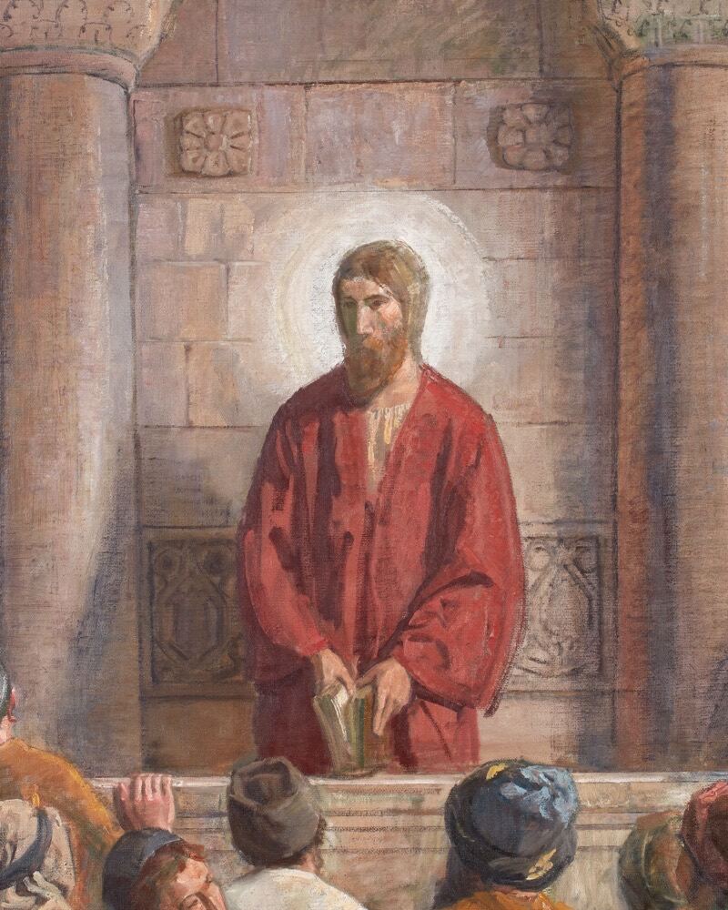 Jesus in a red robe stands at the reading desk of a synagogue, a book in His hands, as men in caps listen