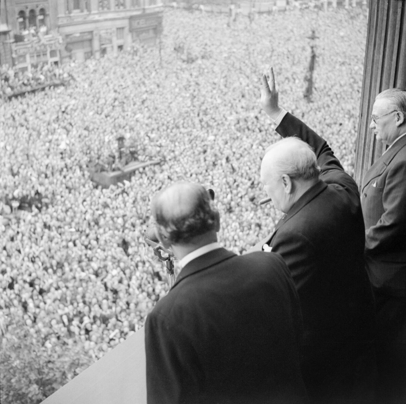 Winston Churchill waves to the crowds in Whitehall on VE Day, 8 May 1945